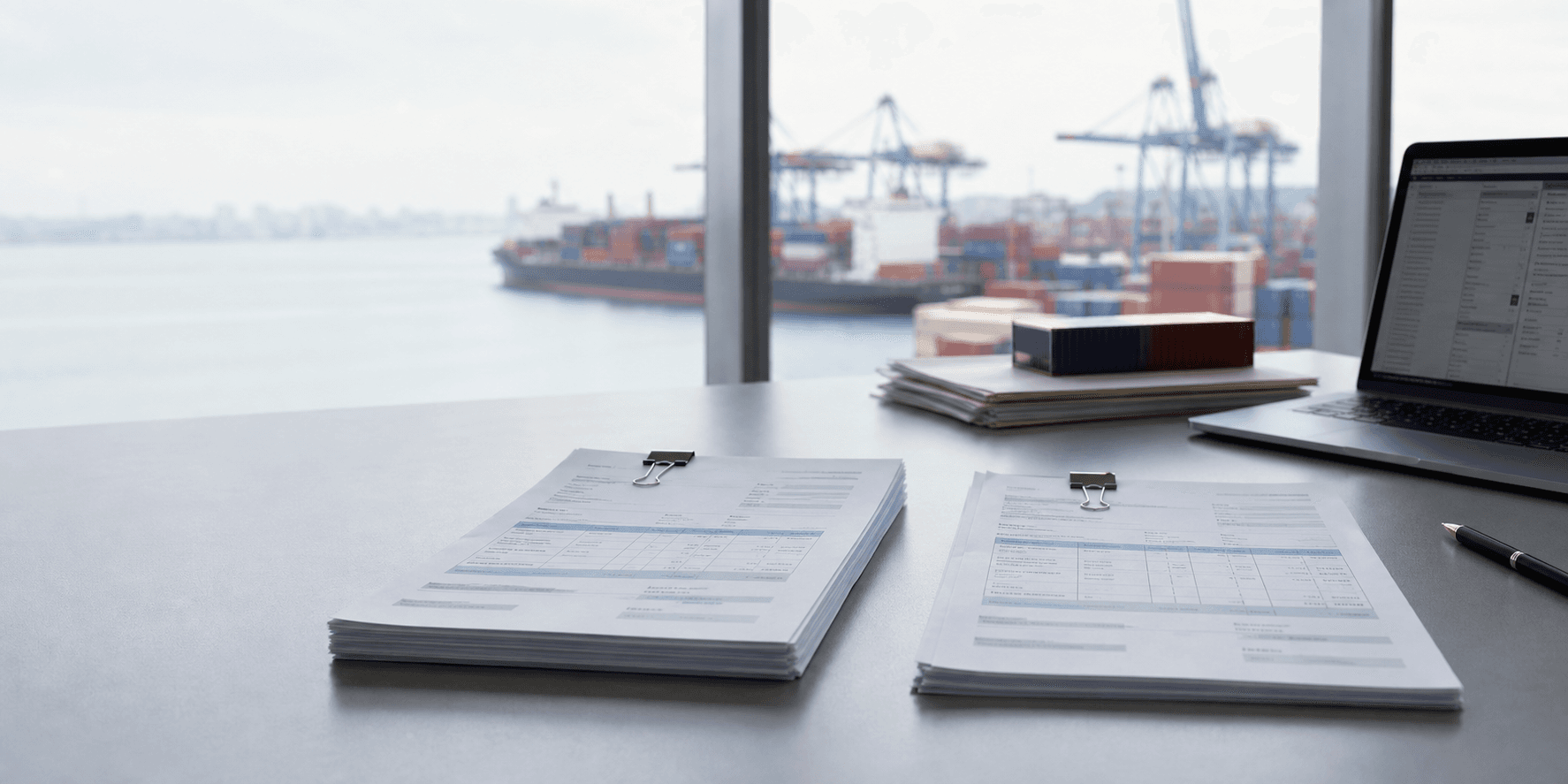 A proforma invoice and a commercial invoice side by side on an exporter desk